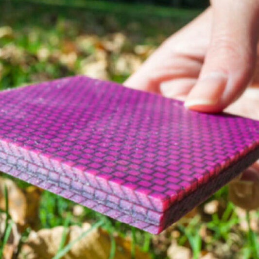 Hand placing a purple block on the ground