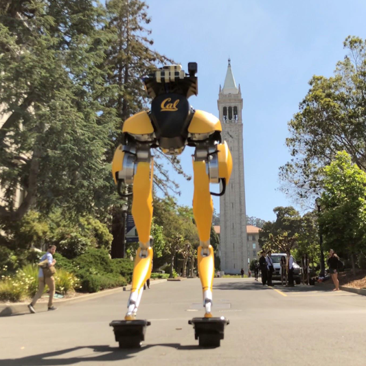 Yellow robot in front of the campanile